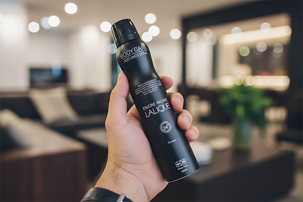 اسپری خوشبوکننده لالیک در دست مرد